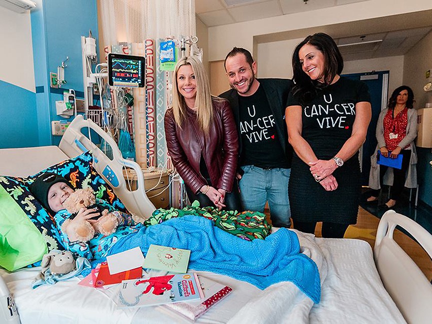 Founders, Kelley and Ryan LaFontaine delivering U CAN-CER VIVE Valentine's Day Care Packages to Cancer patients at a hospital, where we have funded research grants.