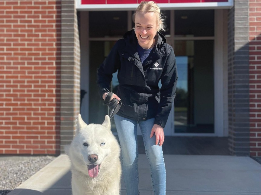 Ricki (dog-walking volunteer) is pictured at the entrance to the new Nancy Shuman Animal Shelter at KVHS. Impact