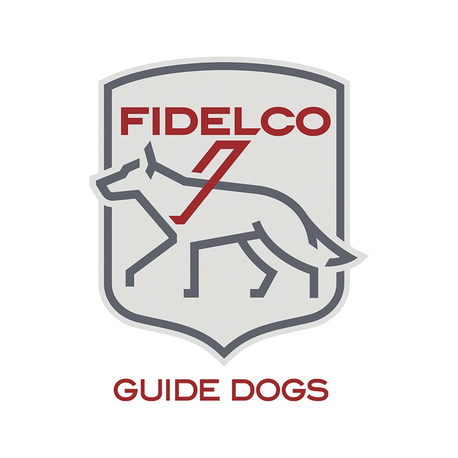 A Subaru Outback proudly displays Fidelco logos, symbolizing our longstanding partnership with Suburban Subaru to serve individuals who are blind through independence, mobility, and life-changing guide dogs.