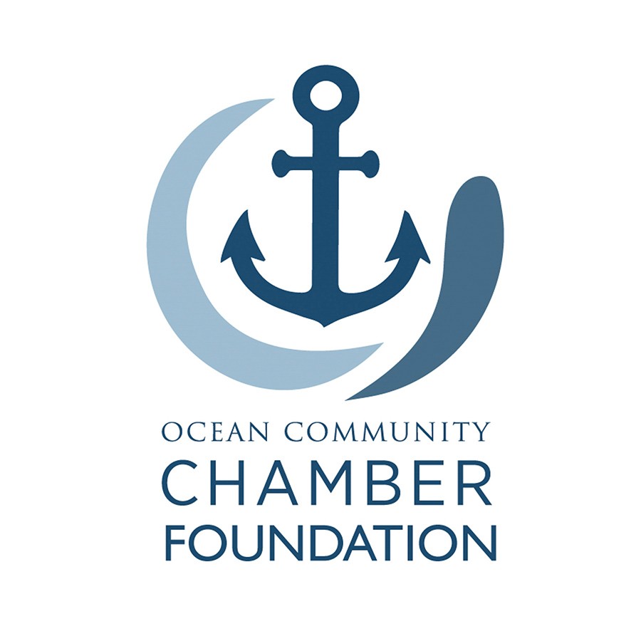 Bruce Morrow, GM of Valenti Subaru, holds painted buoys in the showroom for the Stonington Lobster Trap Tree. Share the Love funding allowed kids to decorate buoys at free workshops for the six-week outdoor art exhibit.