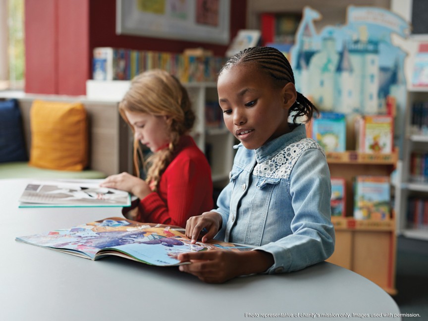 Students receiving books and participating in a literacy program hosted by Malcolm Mitchell and Patriot Subaru of North Attleboro. Impact