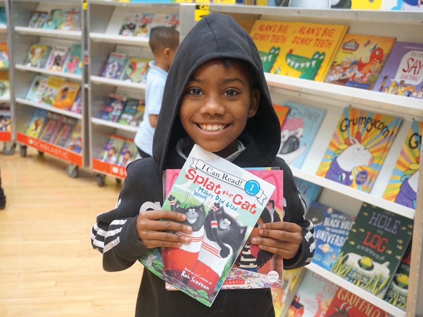 This photo is of a child who is happy that he was able to select new books through one of our UWDE early childhood reading programs, My Very Own Library. Reading on grade level by 3rd grade is critical to success in school, and MVOL helps. Impact