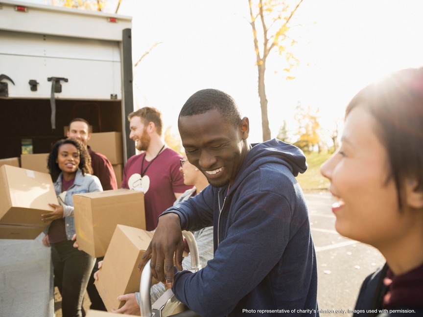 The photo illustrates the heart of the Red Cross' mission, providing universal humanitarian aid. Pictured are dedicated Red Cross volunteers as they install smoke alarms and develop fire emergency plans for residents in a high-risk community. Impact