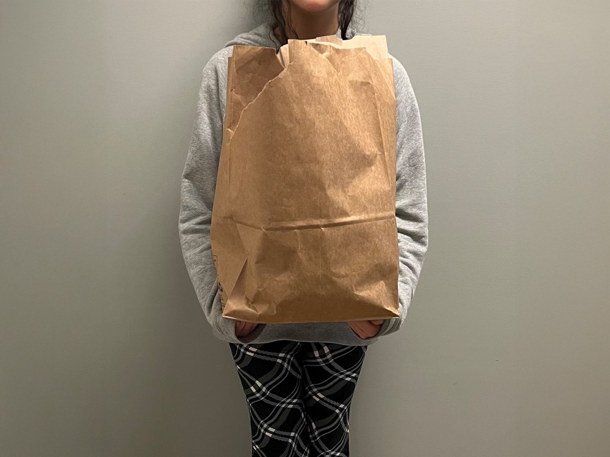 This is a picture of a resident on the day she arrived at Jesse's House. All of her belongings fit in the paper bag she is holding. Impact