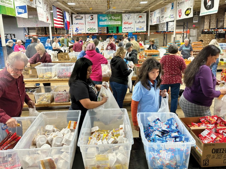 Volunteers packing Snack Pak bags at Snack Pak 4 Kids. Impact