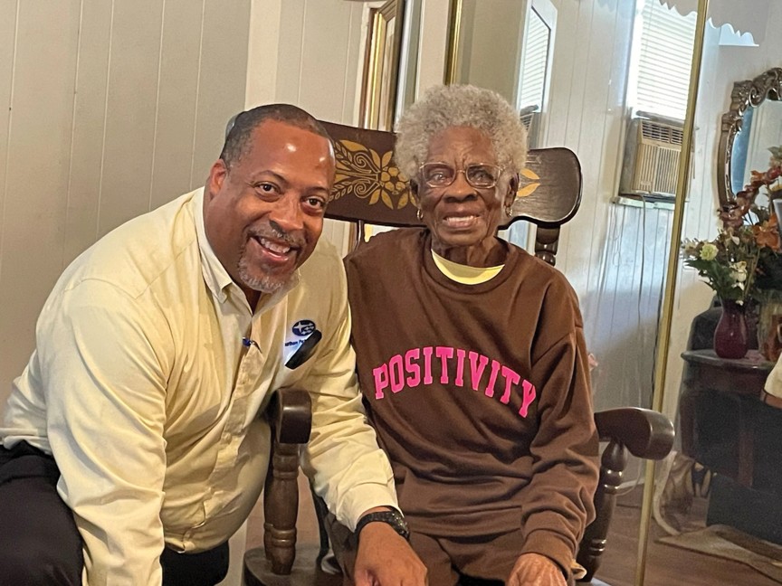 A volunteer spends time with a Meals on Wheels client. Impact