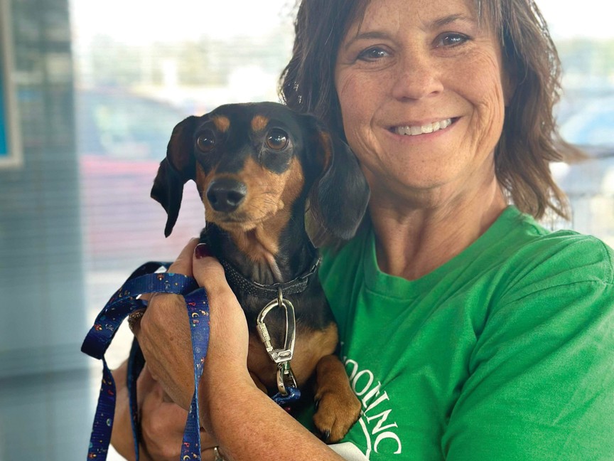 Lisa, one of our volunteers, poses with an adoptable pup during a Yark Subaru Open House adoption event prior to adoption—one of many ways we connect rescued pets with loving homes through community partnerships. Impact