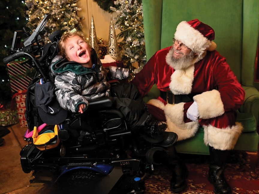 An Wish Kid visits with Santa Claus during A Special Wish Northeast Ohio's all-family Christmas event at the Akron Zoo. Impact