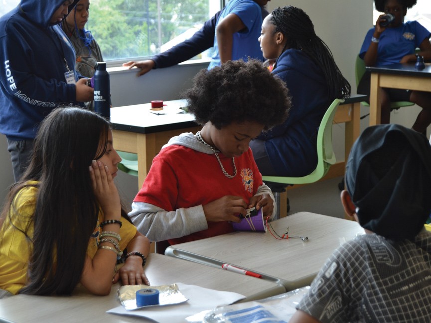 Hope Ignites Scholars working on a STEM project during summer programming. Impact