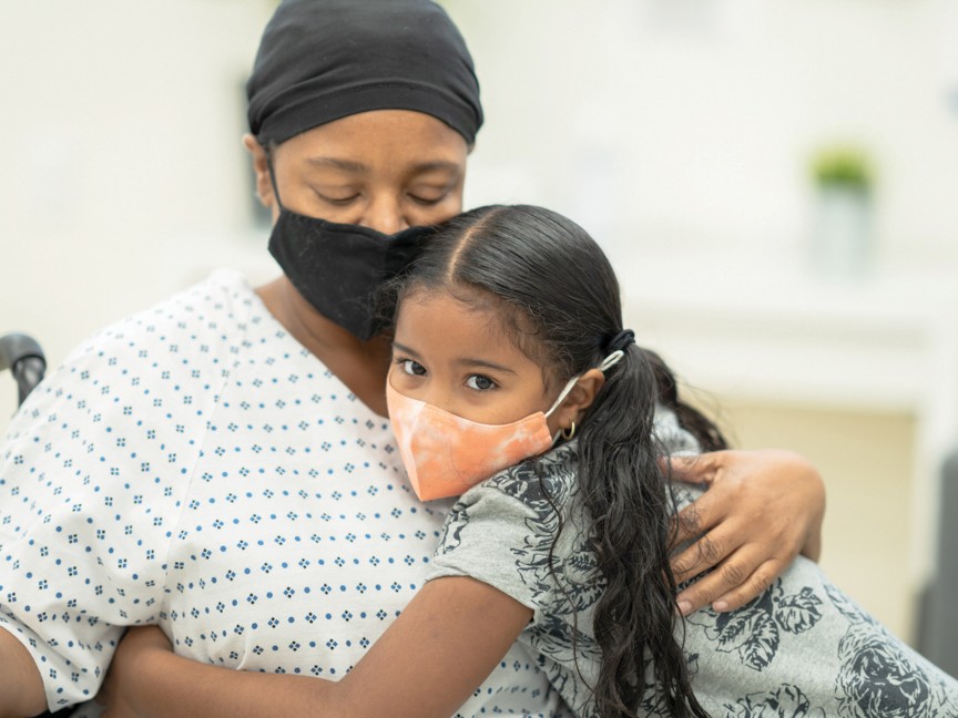 A cancer patient getting a hug from her daughter. It embodies love and hope. Impact