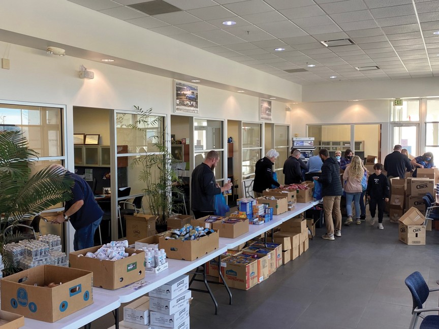 Subaru sales team members and teachers from Thompson School District have a race each year to see who can pack 300 bags each the fastest. Impact