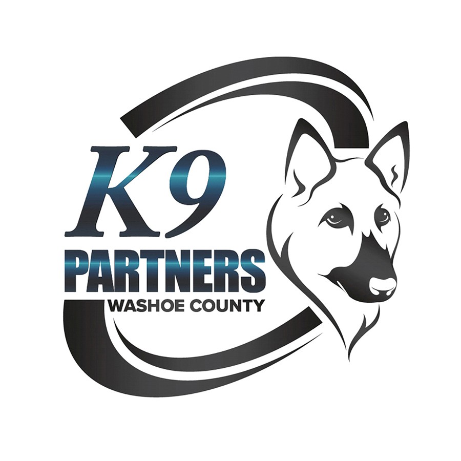 A life size standup of Washoe County Sheriff's Office Deputy Evans and K9 Odin next to our Local Subaru Dealer's Share the Love Event poster.