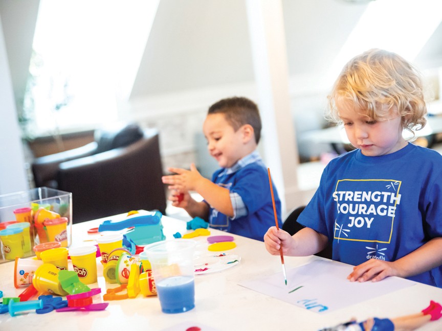 Dragonfly patients enjoy time together crafting at the new Farmer Family Dragonfly Center patient space. Patients enjoy the Craft Corner in addition to a special library, game room, and free space that remains open to all families during the week. Impact