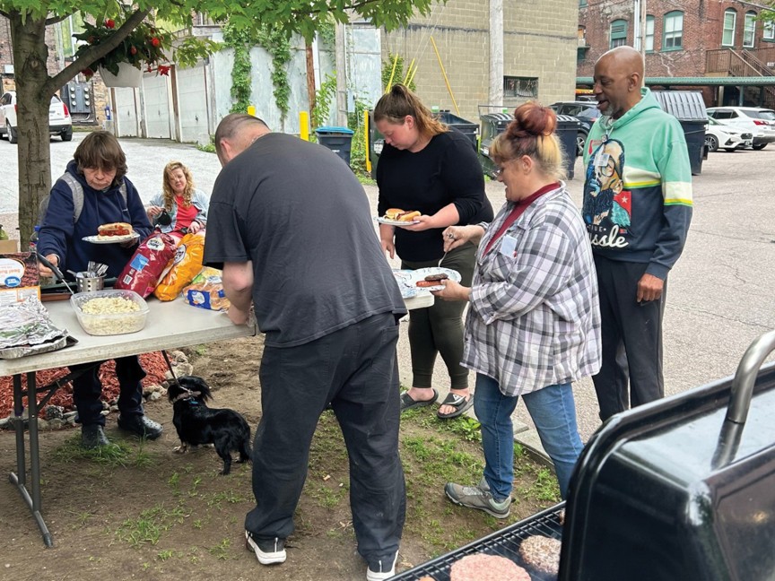 Samaritan House staff hosts a BBQ for shelter guests. Impact