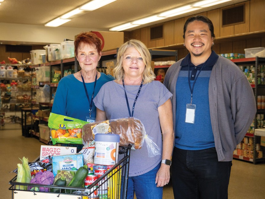 Sloan Chau, Food & Nutrition Program Manager, with volunteers in Community Resource Center's food pantry as they provide healthy food for a client experiencing hunger and in need of food assistance. Impact