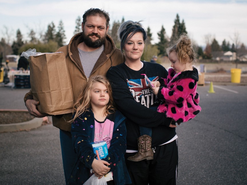 A Feeding America image highlighting a family receiving assistance. This family is representative of neighbors like those we are able to support through the Share the Love Campaign. Impact