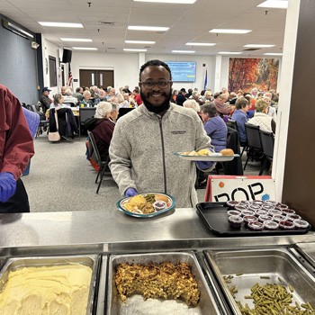 Gengras Subaru employees serve Thanksgiving meals to 180 senior members at the Sullivan Senior Center. Impact